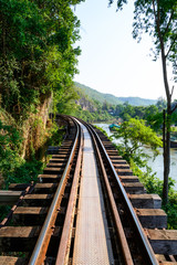 Fototapeta na wymiar Train track with river and mountain view, railway in Thailand