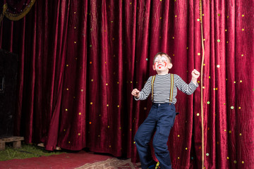 Exuberant little boy performing on stage