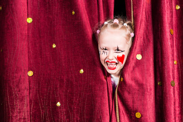 Pretty excited little blond girl on stage
