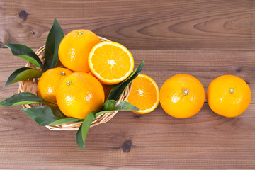 basket of oranges on wooden board