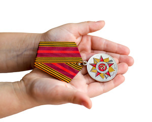 Medal in the hands of a child. isolated on white background