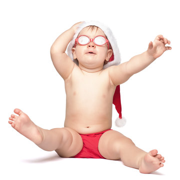 little cute baby in red Santa hat and red glasses