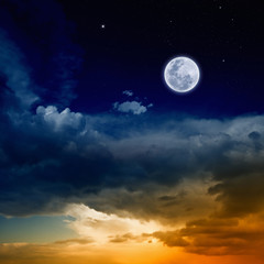 Obraz na płótnie Canvas Glowing sunset and full moon