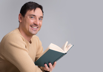 smiling man reading a book