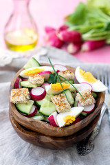 Salad with radish, cucumber, eggs and bread croutons