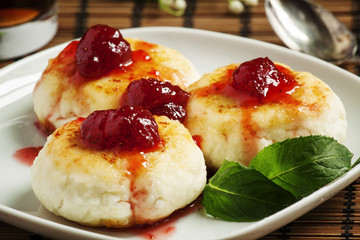 Homemade cottage cheese pancakes with strawberry jam, selective