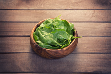 Spinach leaves in a wooden plate