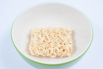Noodles row in bowl isolated on white background
