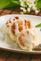Homemade cottage cheese pancakes with white sauce, selective foc