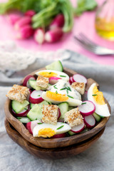 Salad with radish, cucumber, eggs and bread croutons