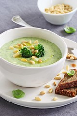 Broccoli-potato  soup with pine nuts and broccoli topping