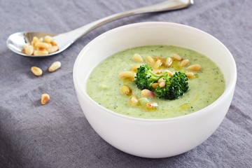 Broccoli-potato  soup with pine nuts and broccoli topping