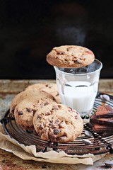 Chocolate cookies with chocolate chips on a rustic wooden table