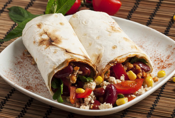 Traditional Mexican food, burritos with meat and beans, selectiv