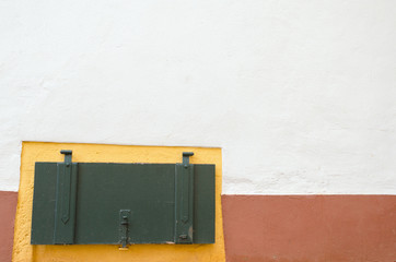 colorful basement compartment closed with a wooden door