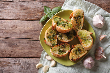 bread with garlic and herbs on plate. Top view horizontal
