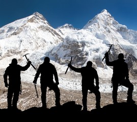Silhouette of men with ice axe in hand, Mount Everest