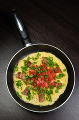 Omelet  bacon slices, tomatoes with herbs