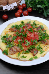 Omelet  bacon slices, tomatoes with herbs