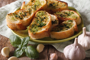 Bread with basil and garlic closeup on plate. Horizontal
