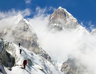 Fototapeta na wymiar group of climbers on mountains montage to mount Lhotse