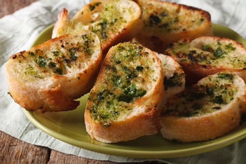 Bread with herbs and garlic closeup on a plate. Horizontal 