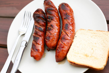 Barbeque sausages on wooden table