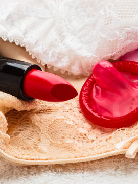 Condom and lipstick on lace lingerie