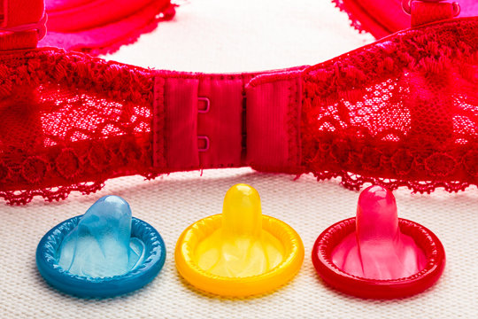 Colorful condoms with lace bra.