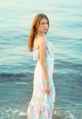 Fototapeta na wymiar Portrait of beautiful young woman against the sea