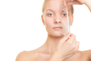 girl removing facial peel off mask