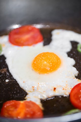 Fried eggs with tomato