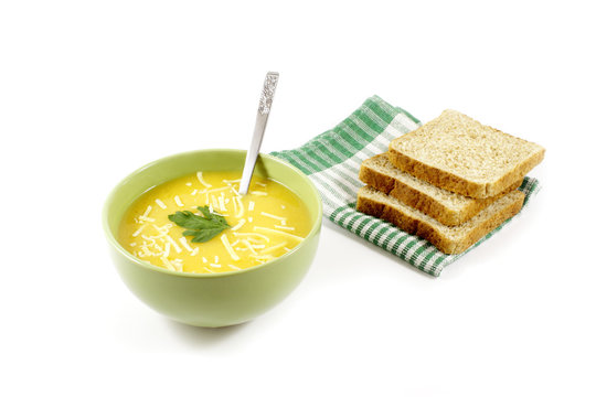 Pumpkin soup with grated cheese and sliced bread