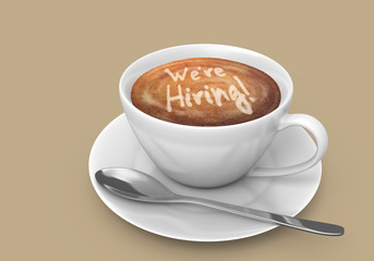 Latte art message in a coffee cup that says we are hiring