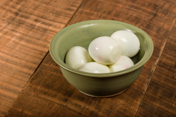 Bowl of peeled hard boiled eggs