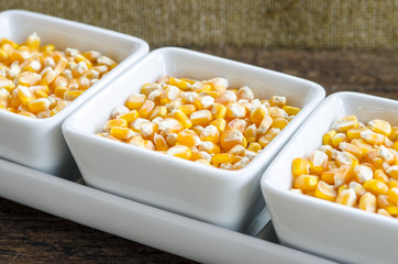 Golden corn grain in the bowl. Shallow depth of field.