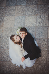 Elegant bride and groom posing together outdoors on a wedding