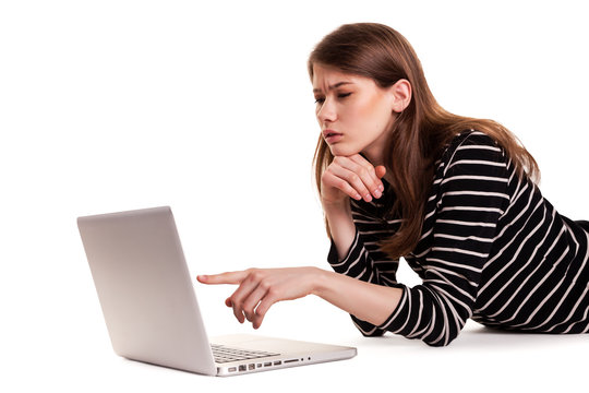 Young Thinking Woman showing PC Screen on Floor Stock Image