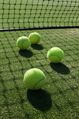 tennis balls on tennis grass court