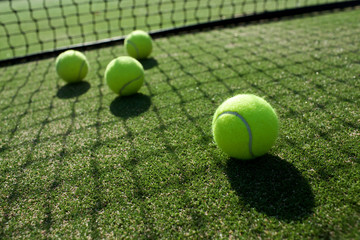 tennis balls on tennis grass court