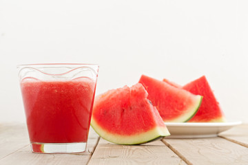 fresh watermelon blending in glass on wood table