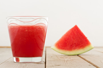 fresh watermelon blending in glass on wood table