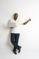 happy casual indian male with a laptop and thumbs up