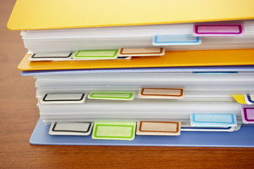 Pile of colorful binders (side view)