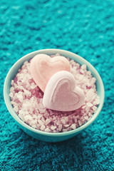 Spa setting with bath salt  and bath accessories on blue towel