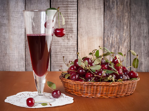 Natural cherries drink in the glass with fresh cherry