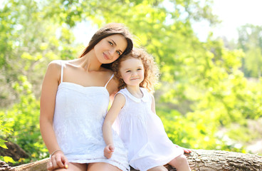 Portrait of happy mother and daughter together outdoors in sunny