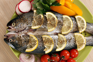 trout fish with salad on plate