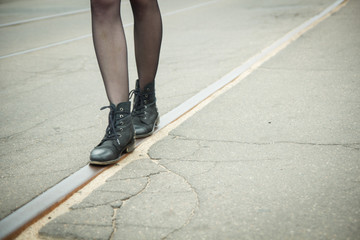 Obraz premium Girl walking on the tracks of the tram 