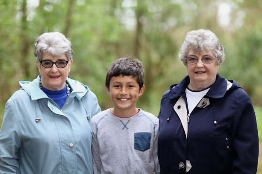 Multi-racial grandson with elderly twin sisters